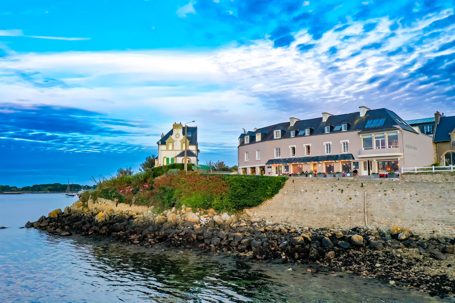 coastal hotel at dusk with cloudy skies - hotel la baie des anges